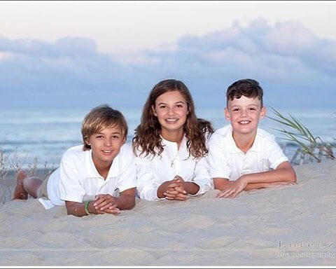 Kids playing in sand during relaxed family portrait session Outer Banks NC