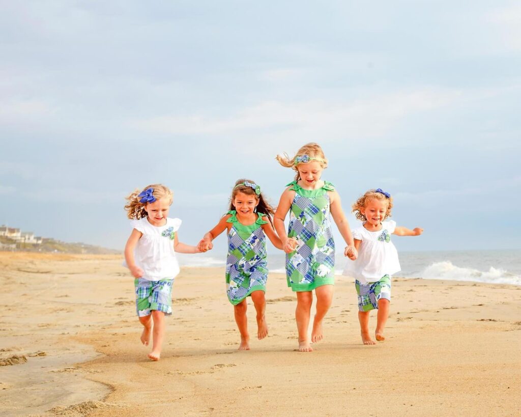 kids running on Corolla beach family portrait