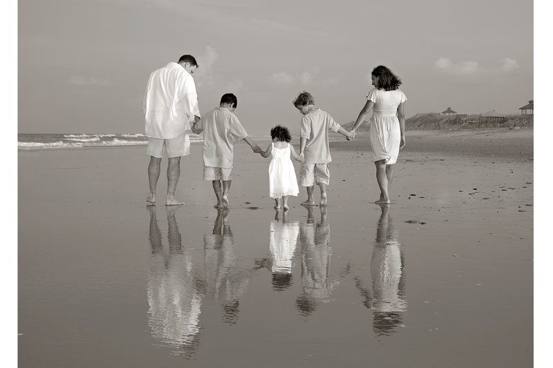 Golden hour family portrait on Outer Banks beach with warm natural light
