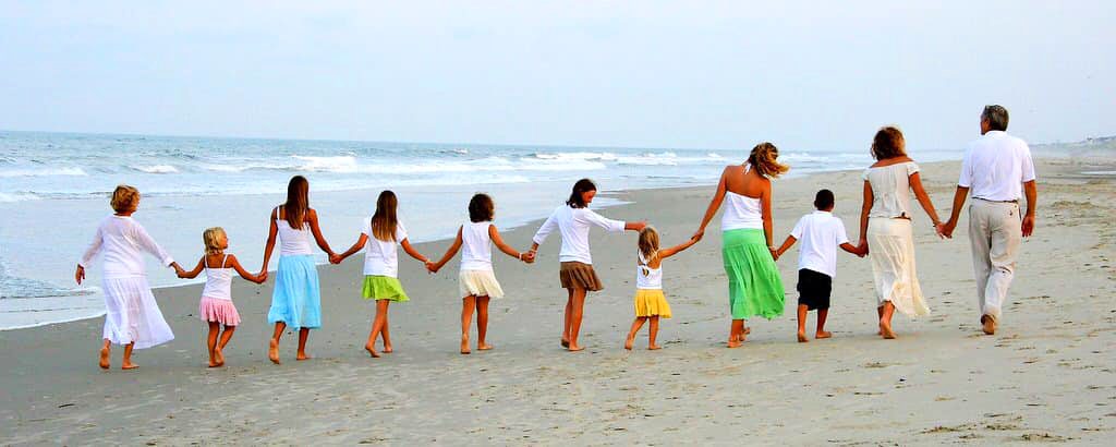 a family walking on the beach in Corolla NC