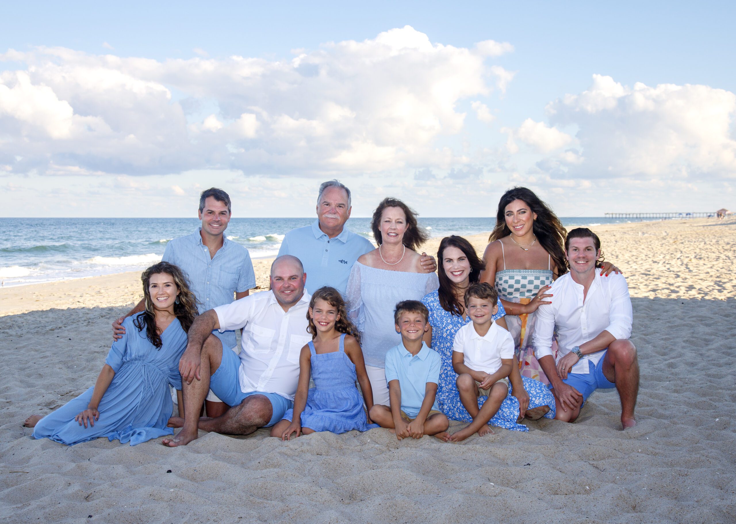 Experienced family photographer directing large group on Corolla beach