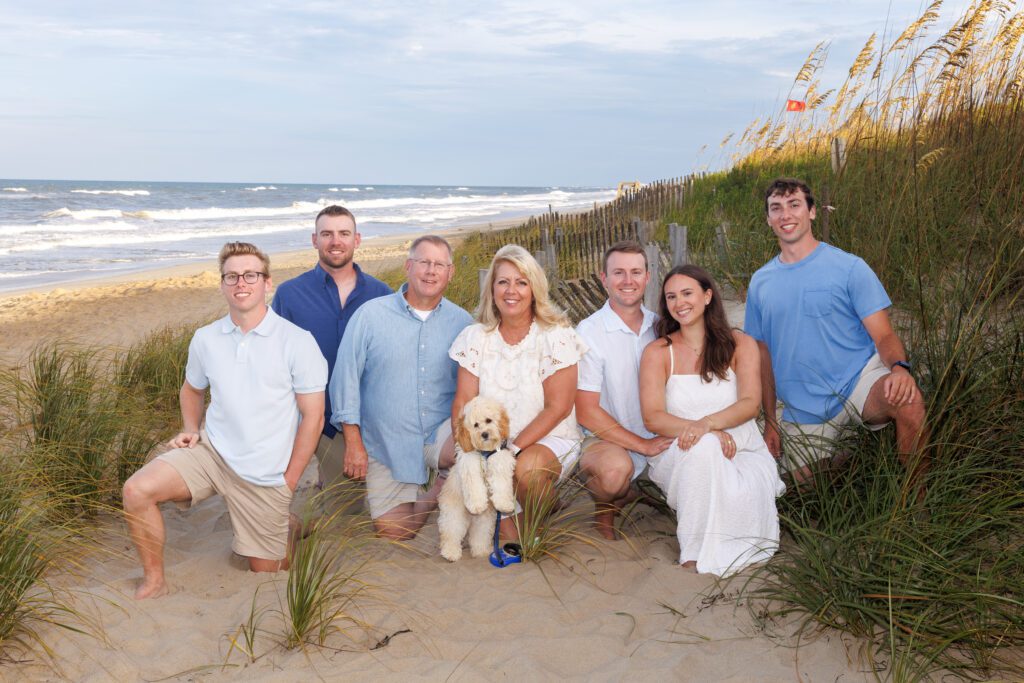 Family relaxing near dunes in Duck NC during beach vacation Outer Banks