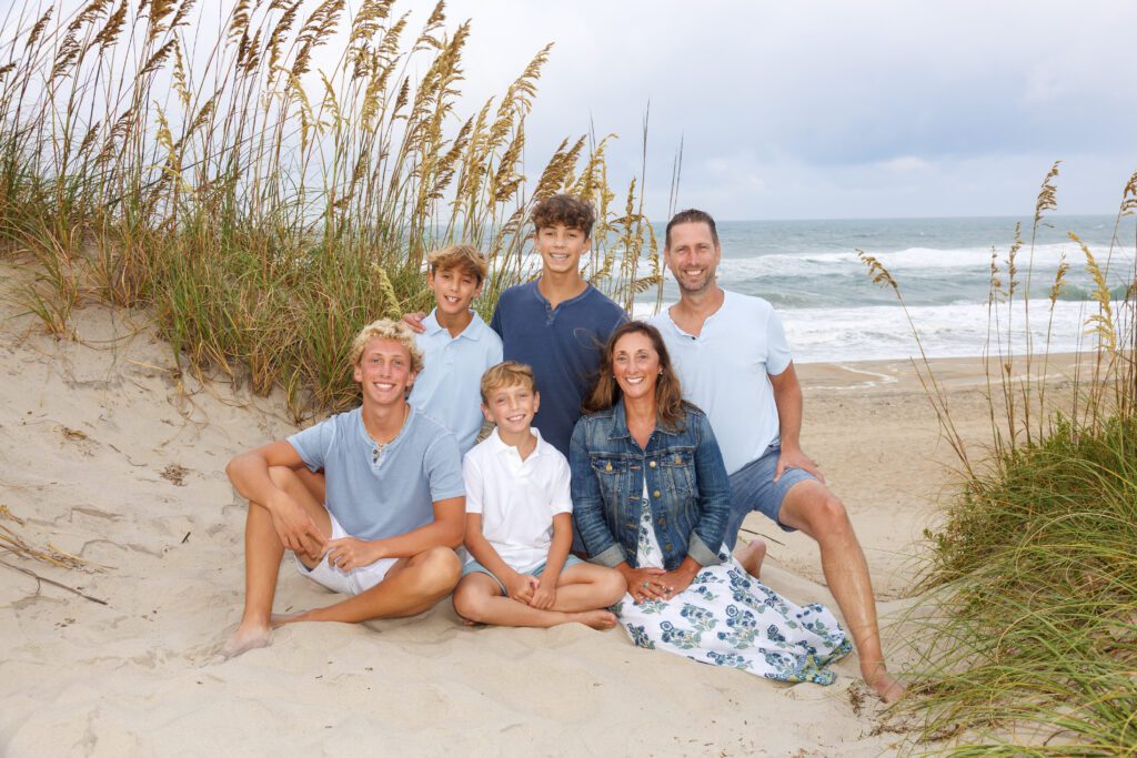 Natural Corolla beach family photos with candid interactions during sunset