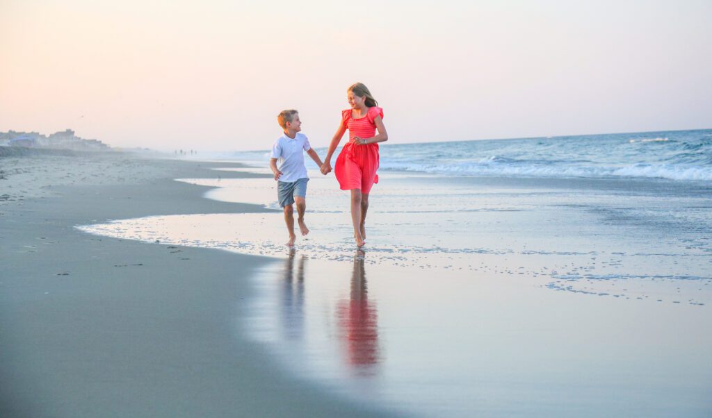 Children playing naturally during Corolla beach family photo session on the Outer Banks