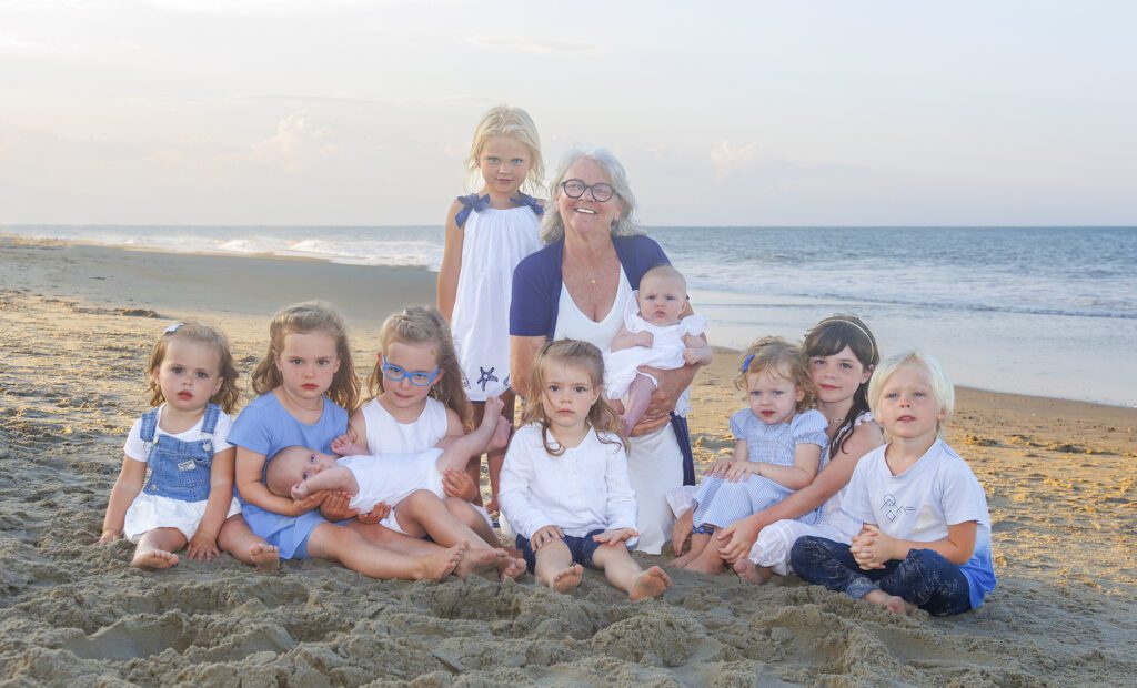 Corolla family photographer engaging children during relaxed beach portrait session