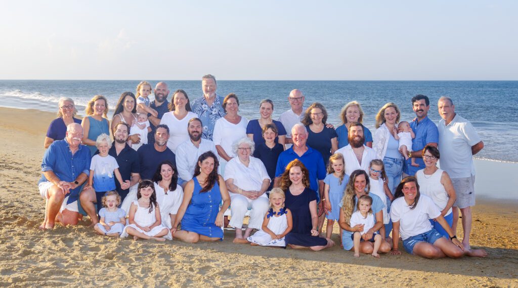 Large extended family portrait on Corolla beach at sunset photographed by OBX family photographer